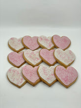 Load image into Gallery viewer, One Dozen heart shaped sugar cookies. Half iced with white and the other with pink icing. All sprinkled with pink sanding sugar.
